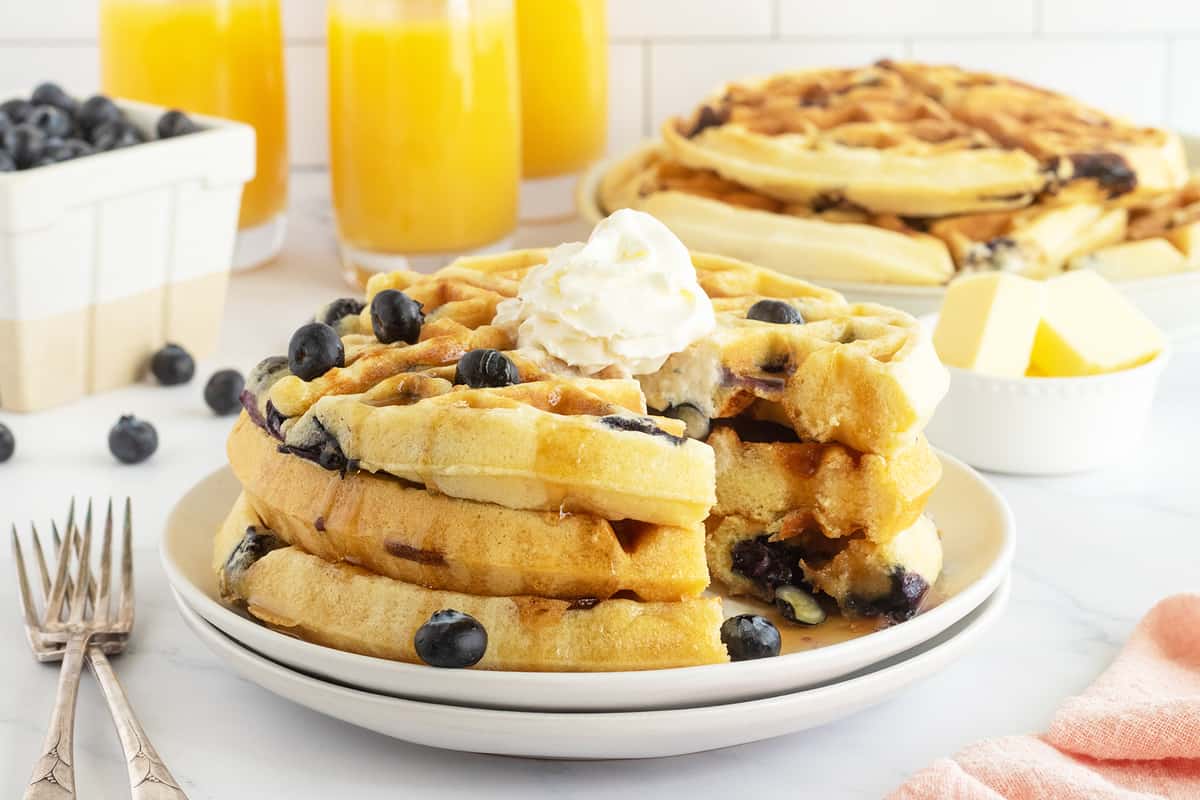 Crispy, golden waffles loaded with juicy blueberries and topped with syrup.