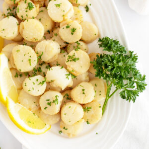 Broiled scallops on a white platter