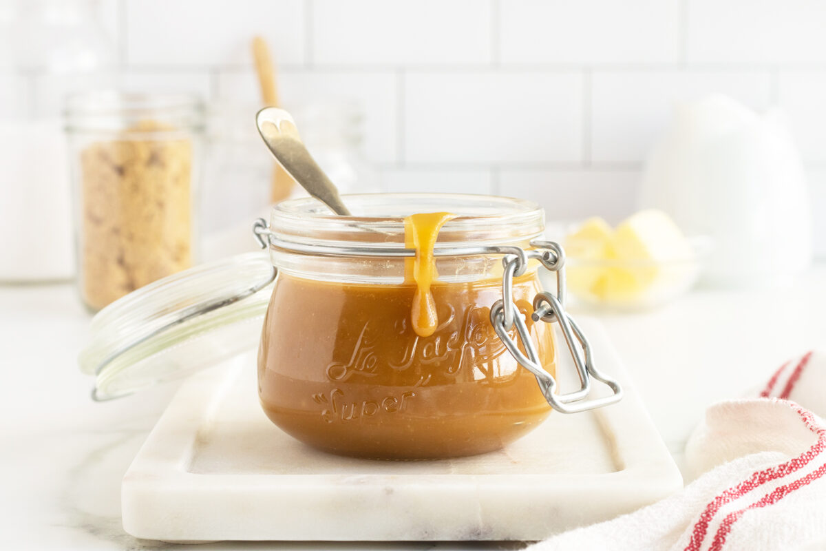 Salted Caramel Sauce in a jar with a spoon
