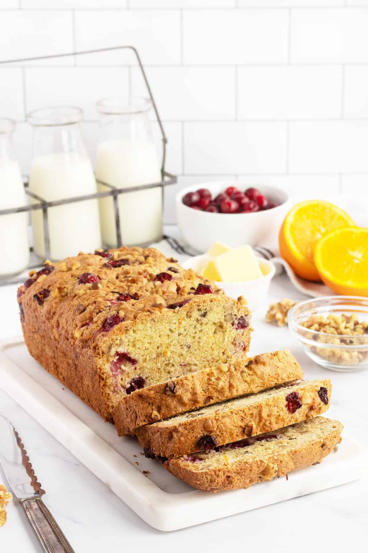Cranberry nut bread sliced on white plate