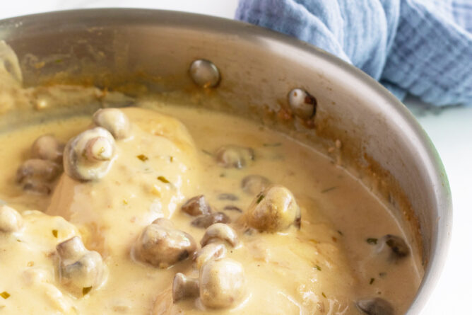Creamy mushroom Tarragon chicken in pan with sauce and mushrooms