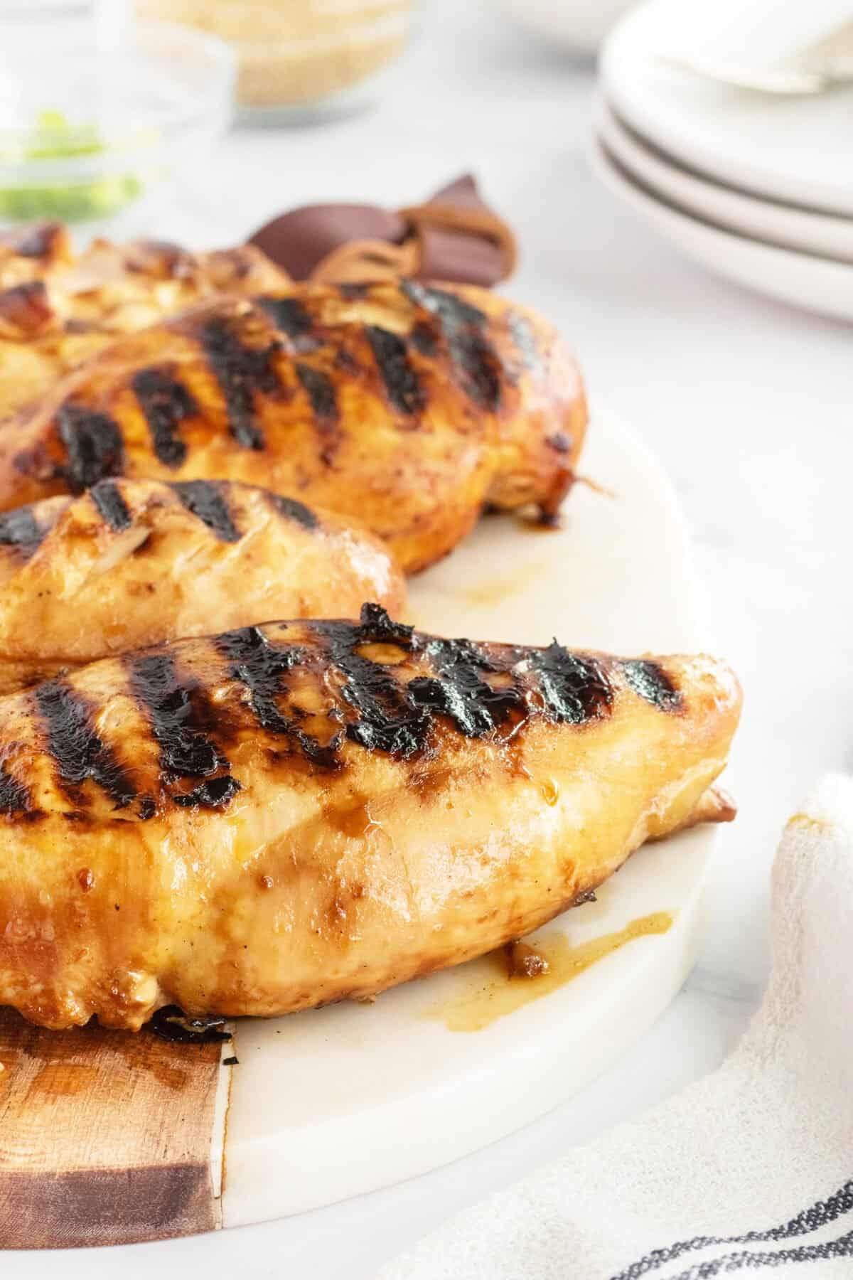 Grilled teriyaki chicken on a white plate