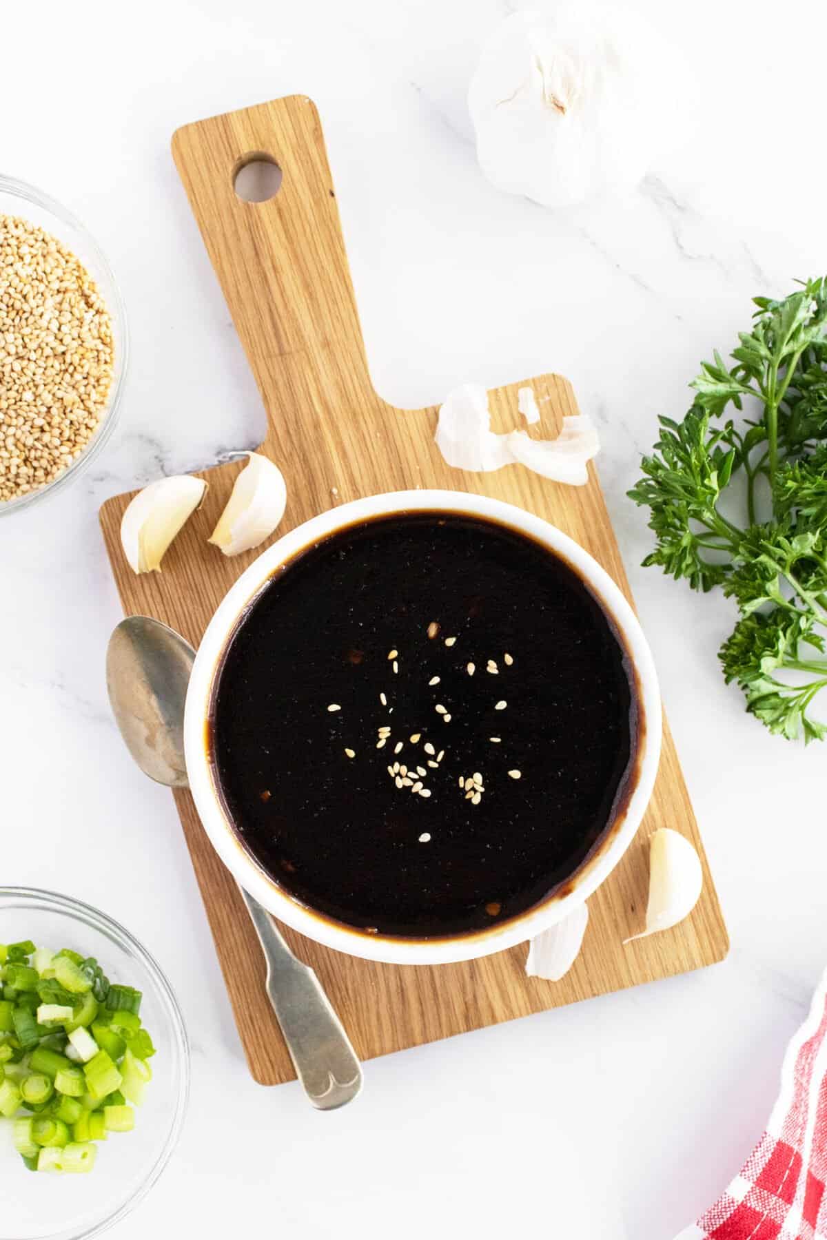 Homemade teriyaki sauce in bowl on cutting board