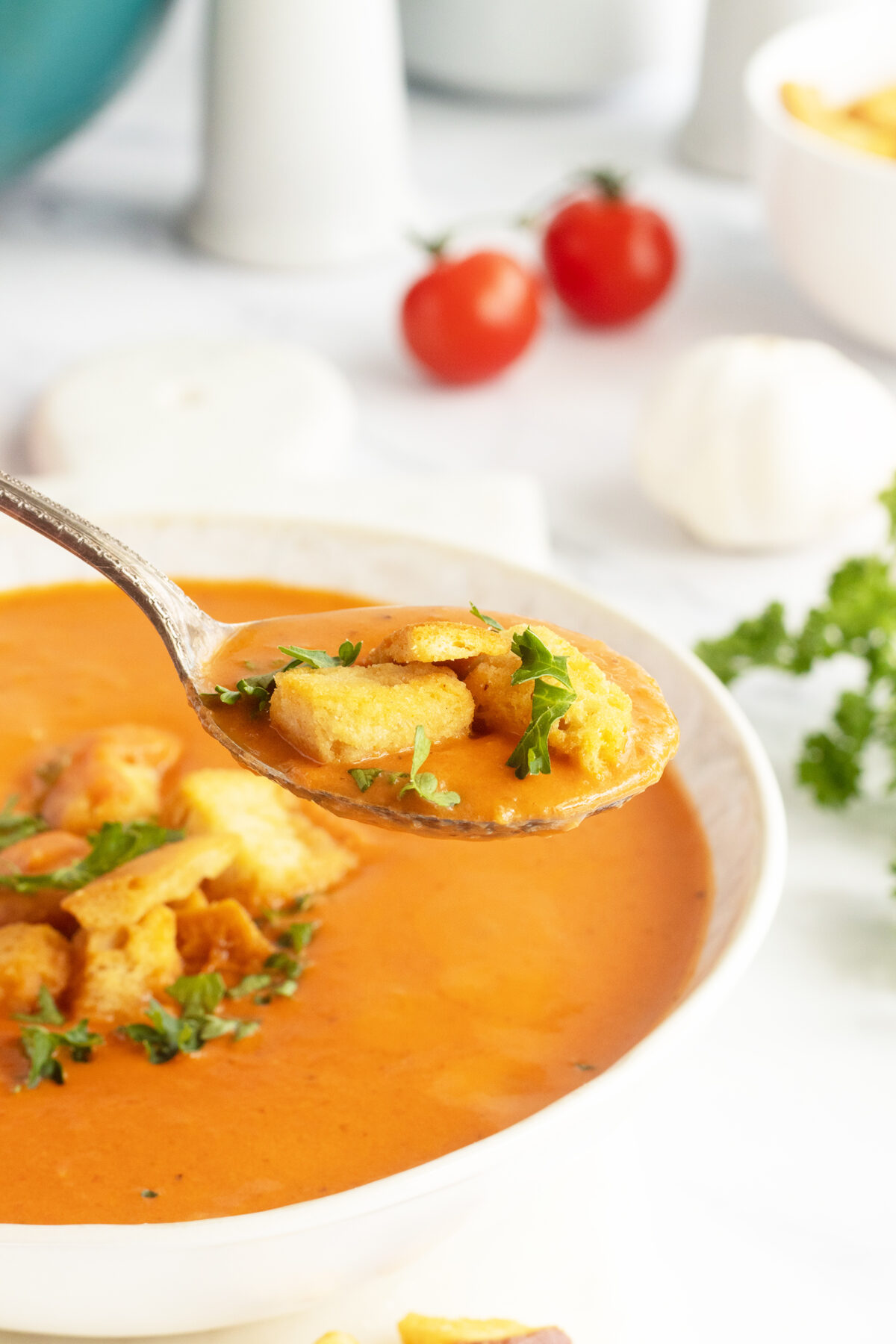 Tomato Bisque with croutons in a spoon