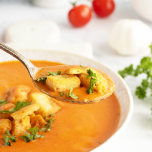 Tomato Bisque with croutons in a spoon