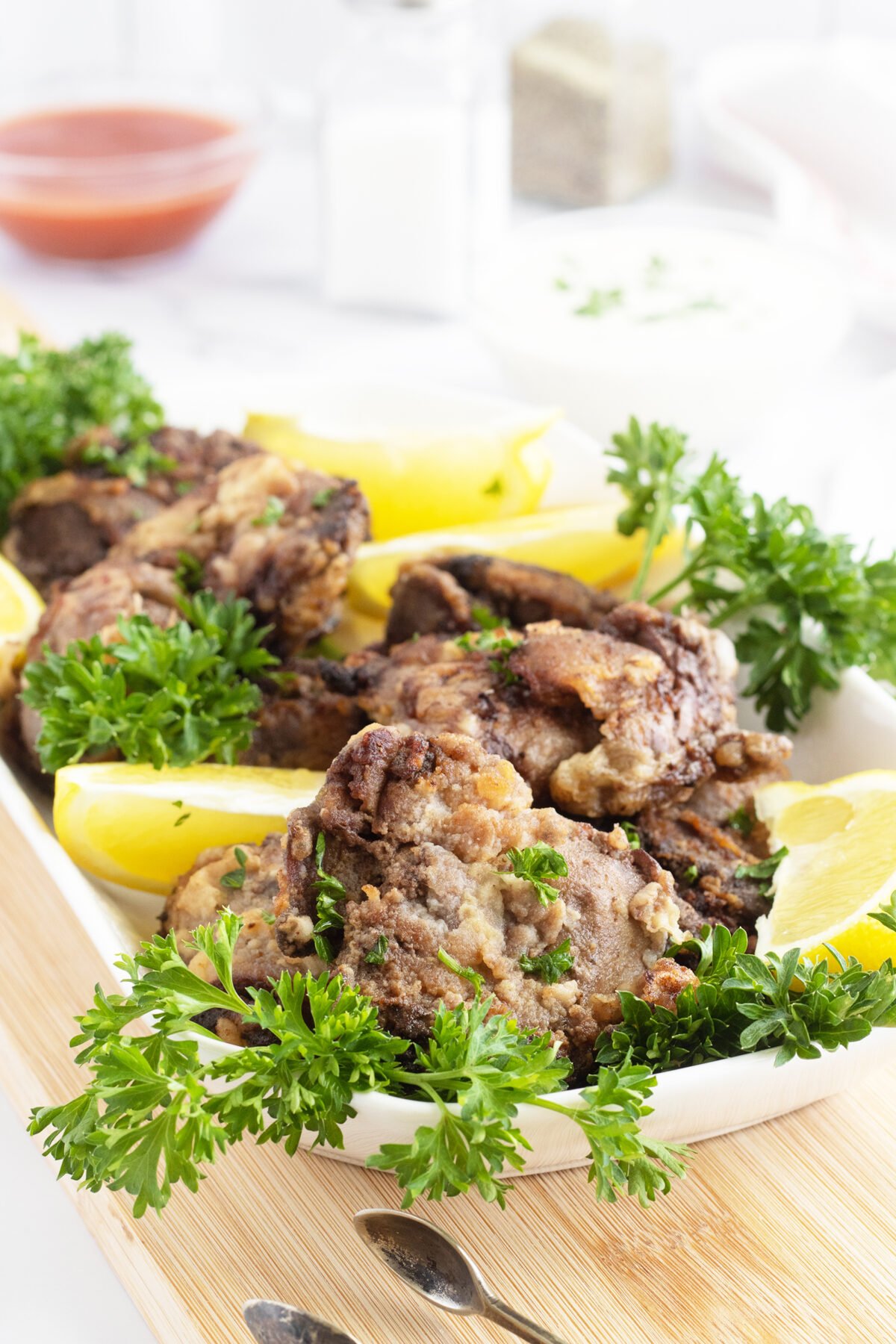 Fried Chicken Livers with parsley on a white platter