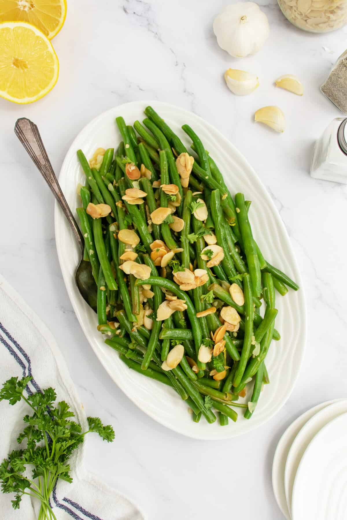 green beans almondine on a plattter with a fork