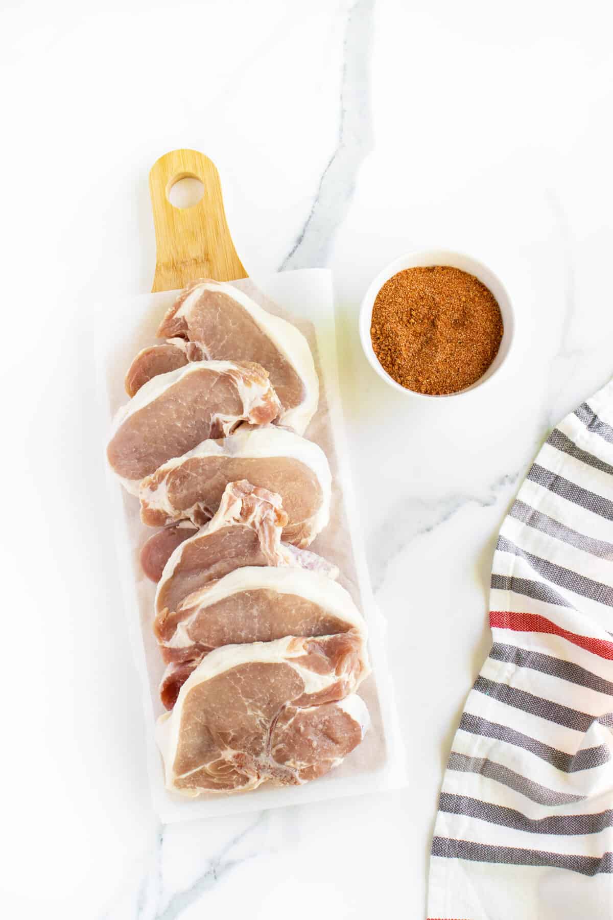 Grilled Pork Chops ingredients on a cutting board