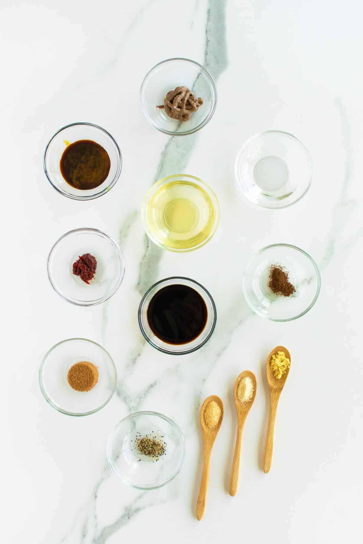 Homemade Worcestershire Sauce ingredients in clear bowls and spoons