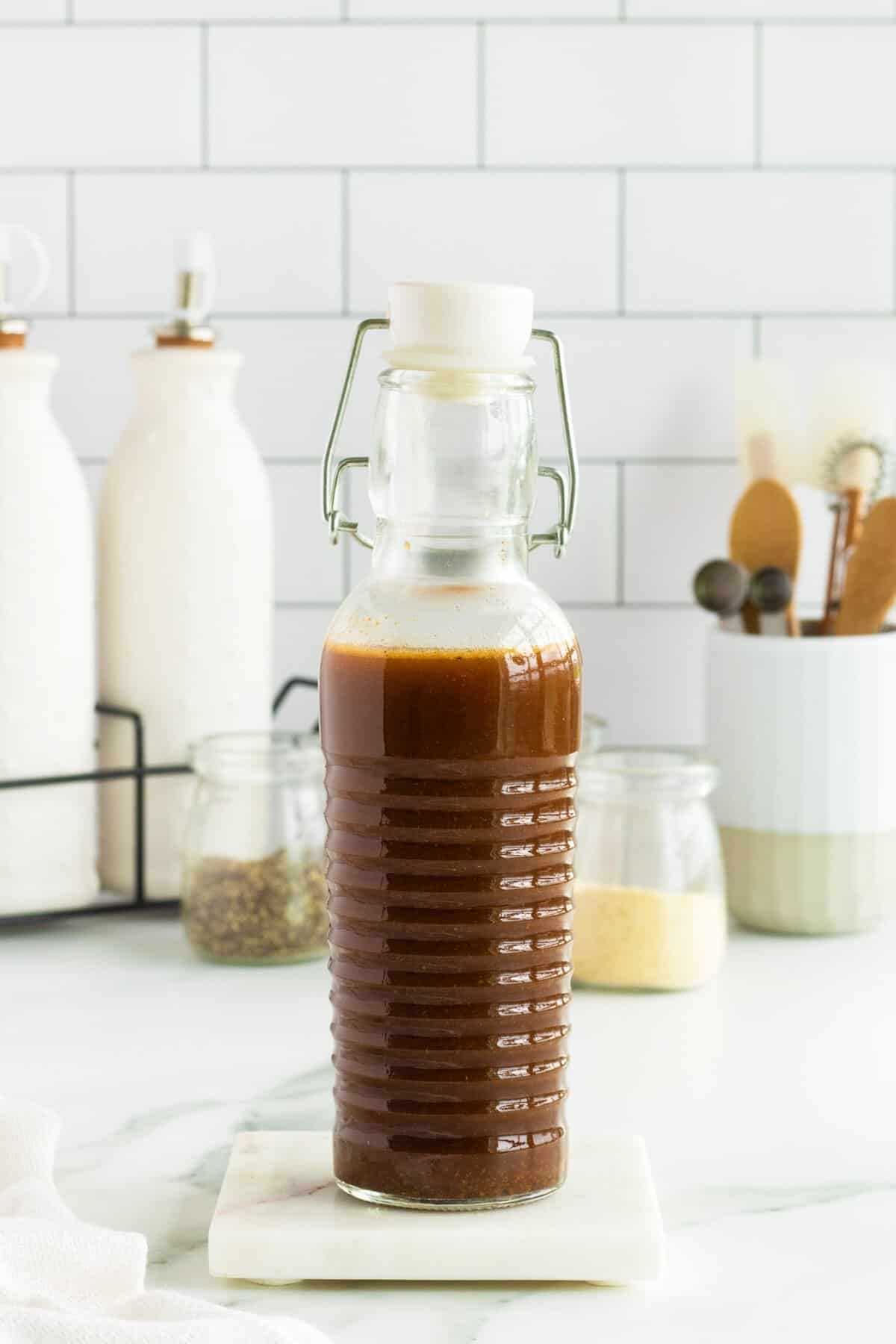 Homemade Worcestershire Sauce in a clear tall bottle with a white stopper