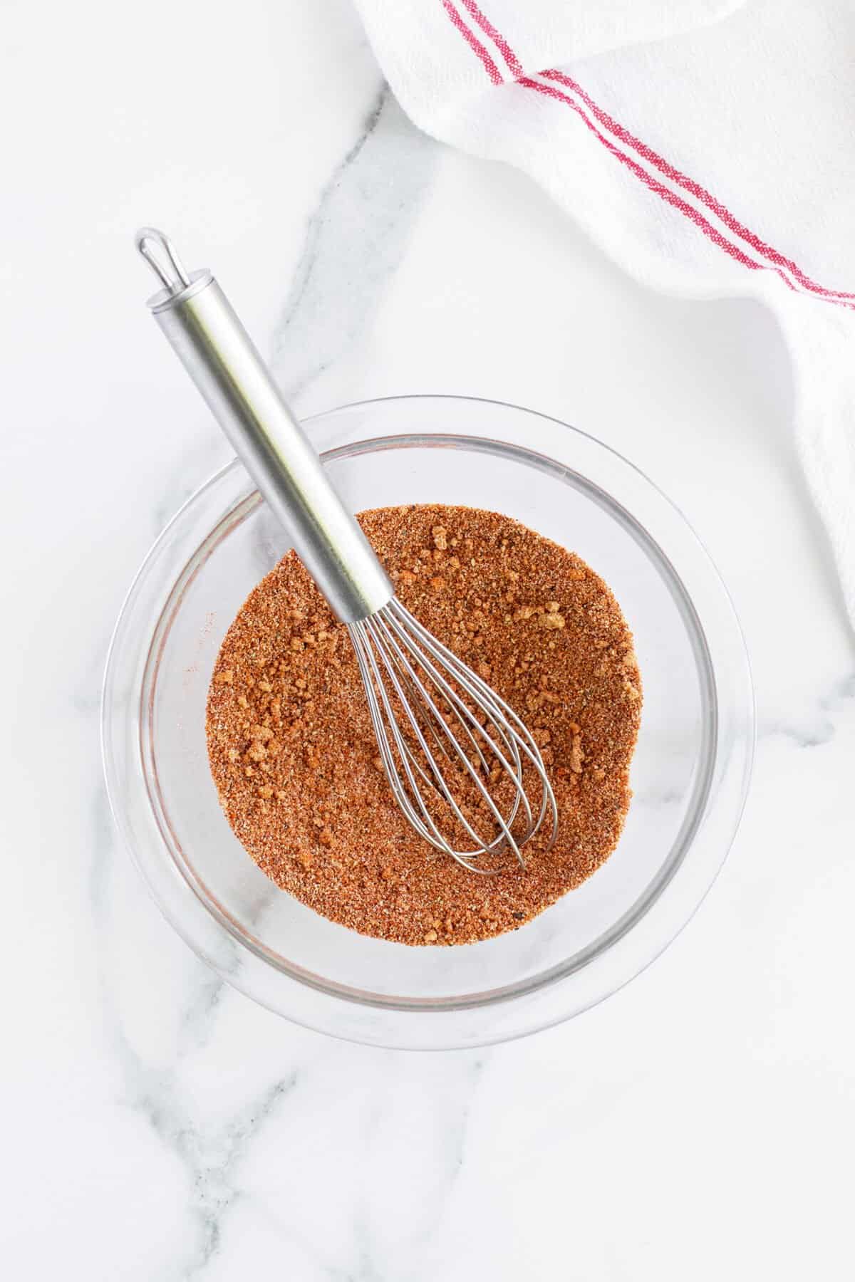 pork chop seasoning with a whisk in the bowl