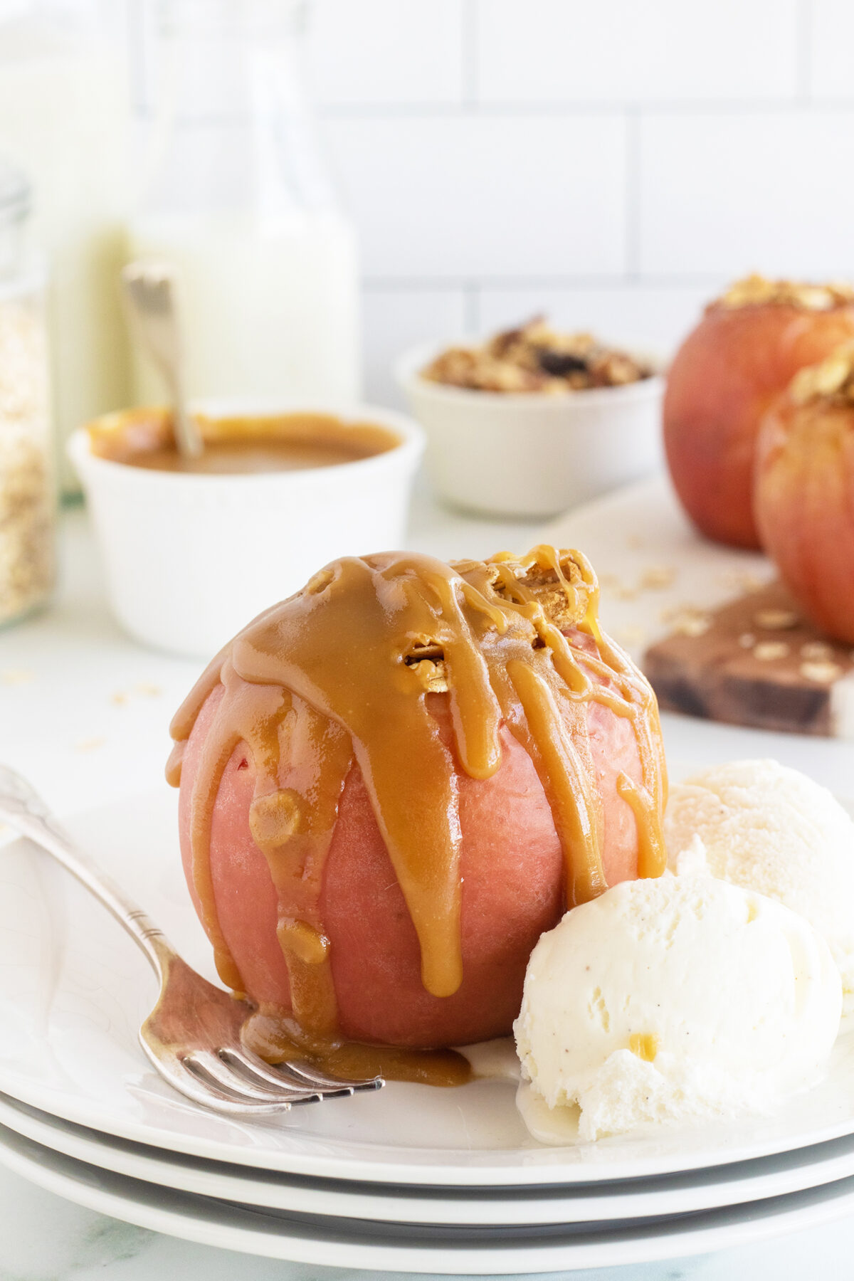 Baked apple with caramel drizzled on top with ice cream