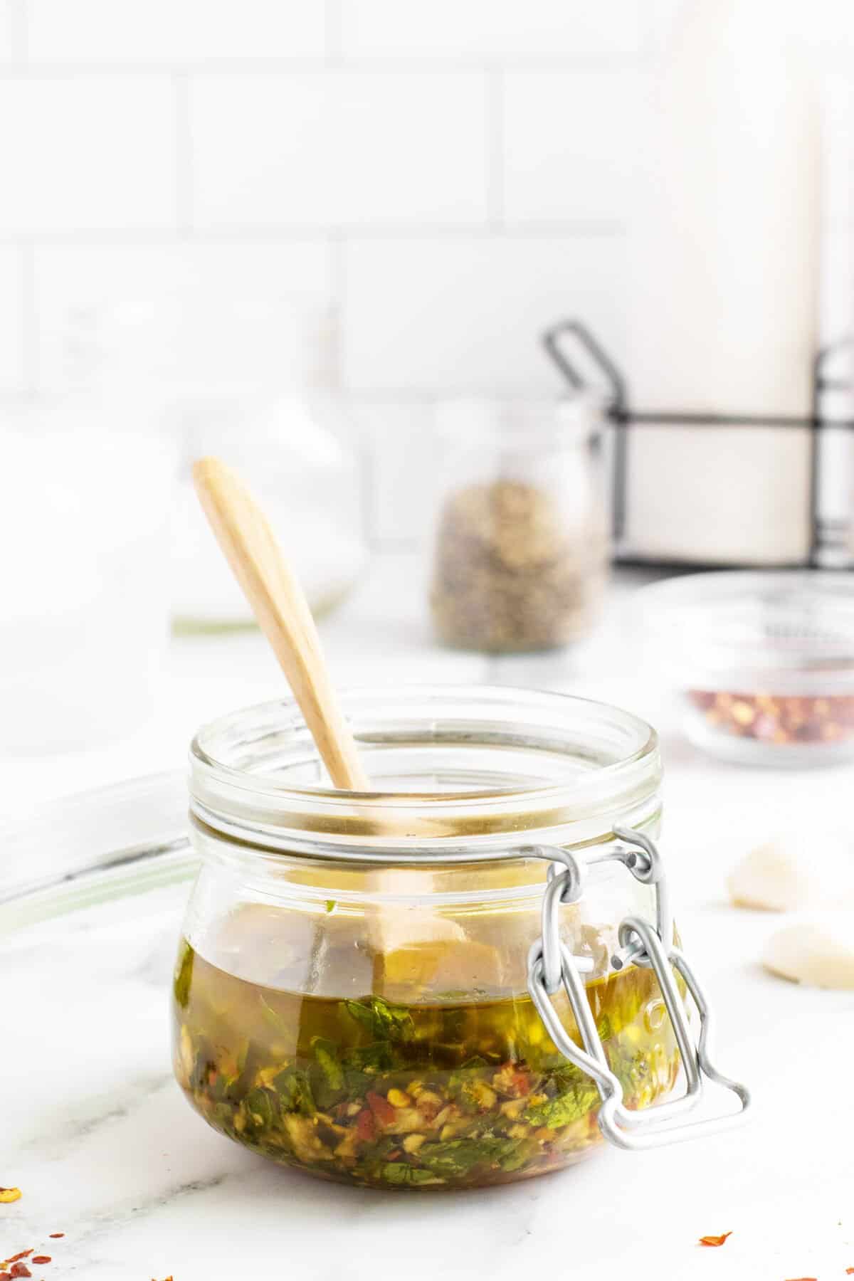 Chimichurri in a jar with a spoon