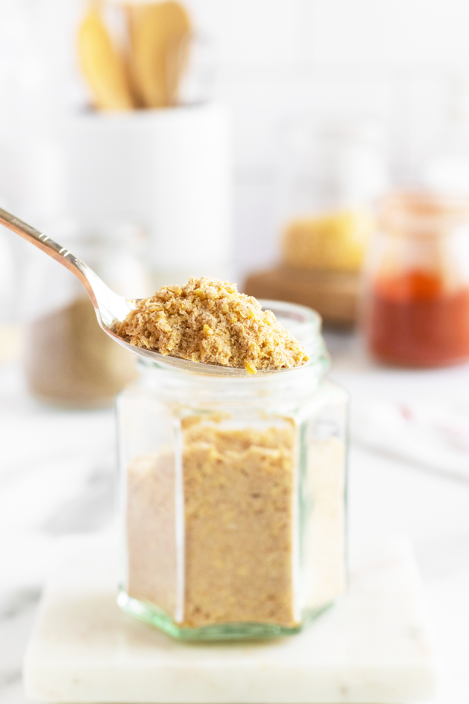 Onion soup mix in a spoon by a jar