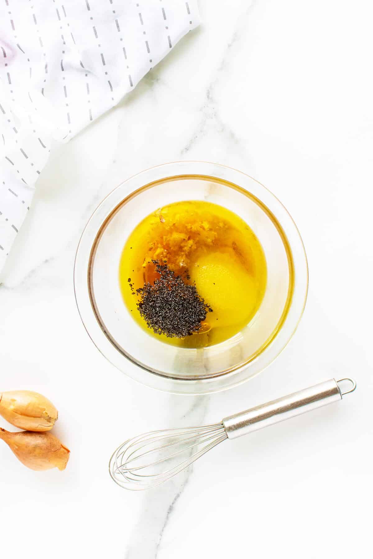 poppy seed dressing in a clear bowl not mixed