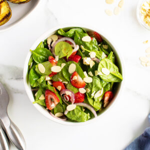 Strawberry spinach salad in a white bowl