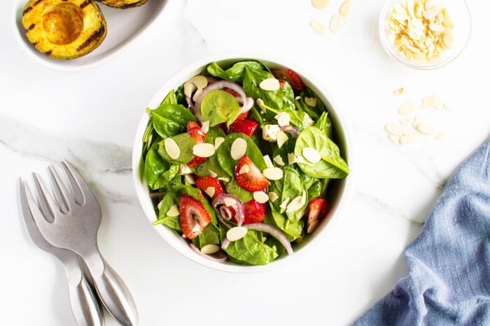 Strawberry spinach salad in a white bowl