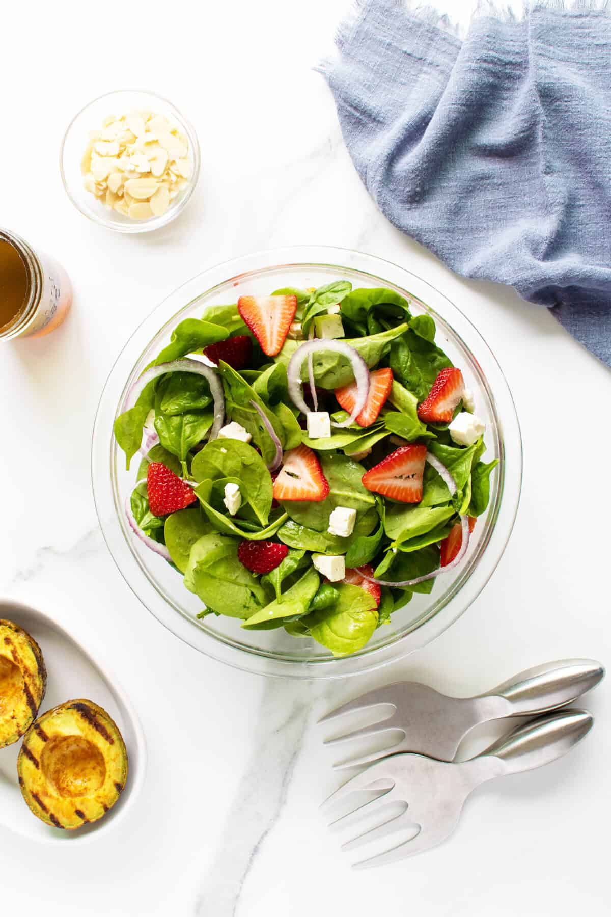 Strawberry spinach salad in a large clear bowl