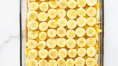 banana split cake with bananas layered in pan