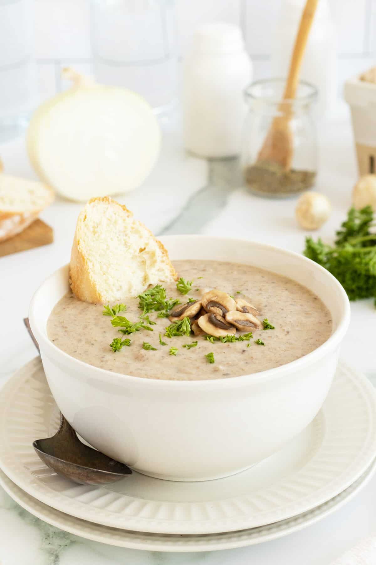 Cream of Mushroom Soup with slice of baguette in bowl