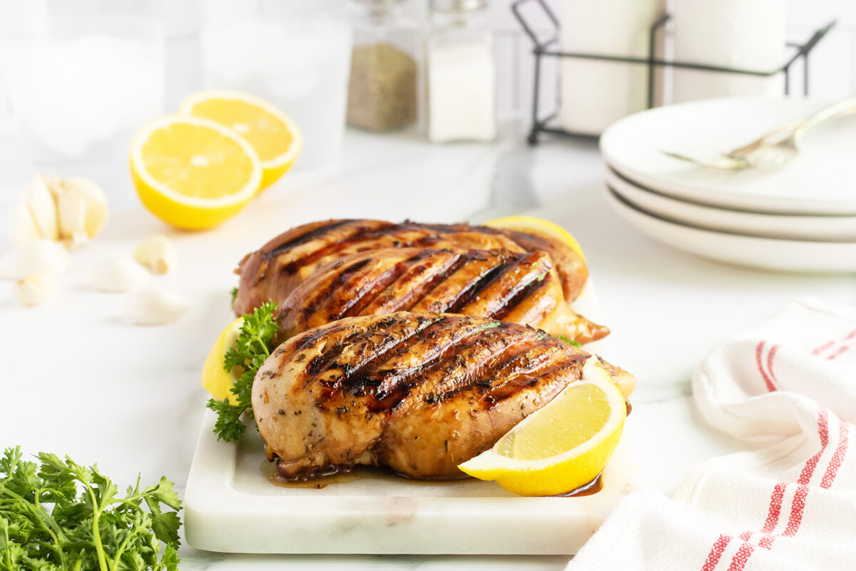 Grilled Chicken Breast on a white cutting board
