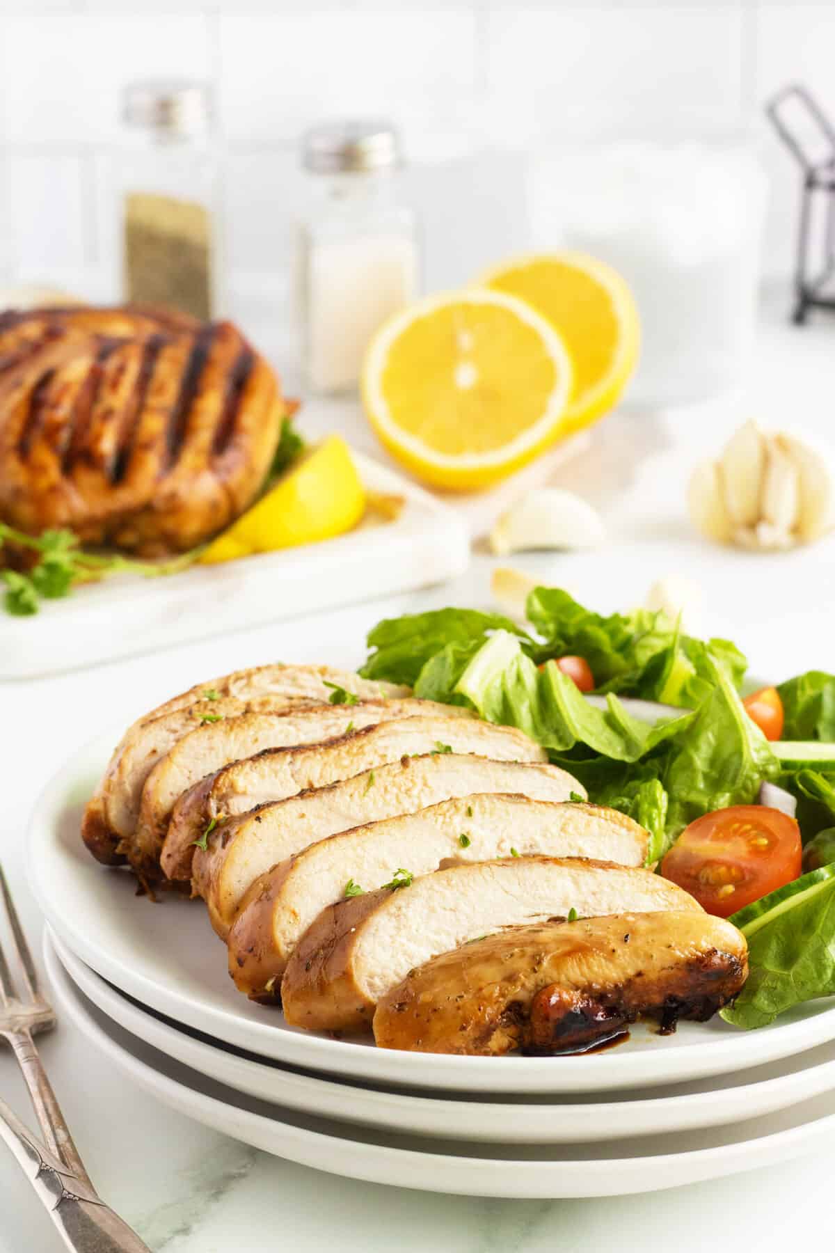 Grilled Chicken Breast sliced on a cutting board