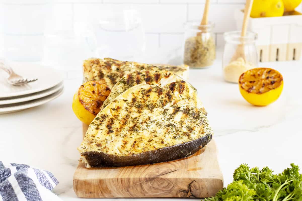 Grilled halibut on a wooden cutting board
