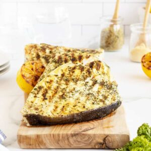 Grilled halibut on a wooden cutting board