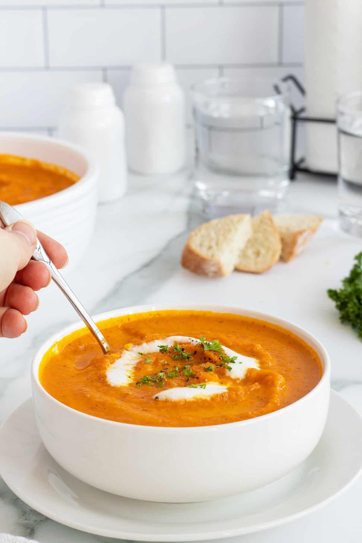Roasted Carrot Soup with a spoon in the bowl