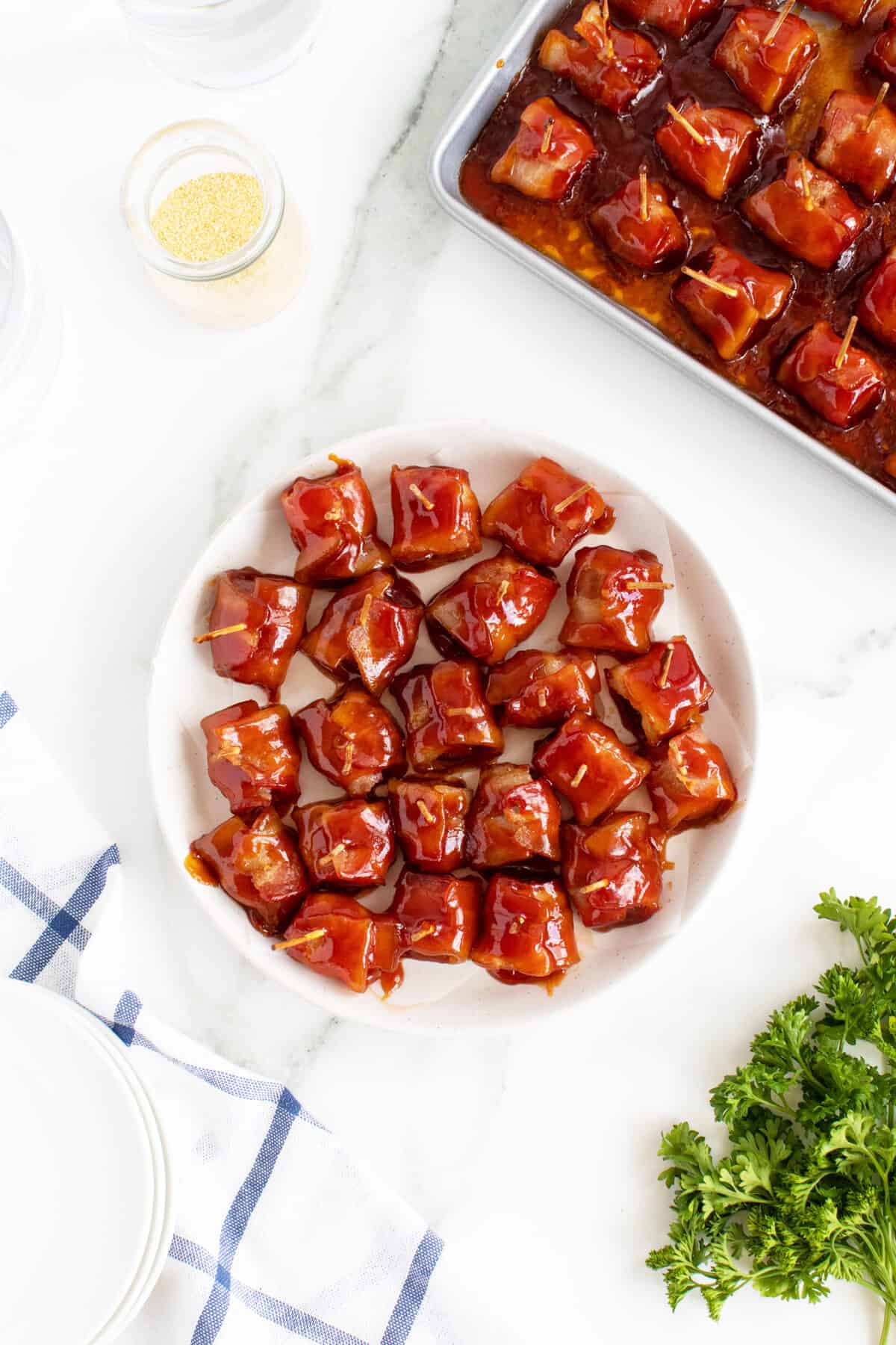 Bacon wrapped water chestnuts on a white plate
