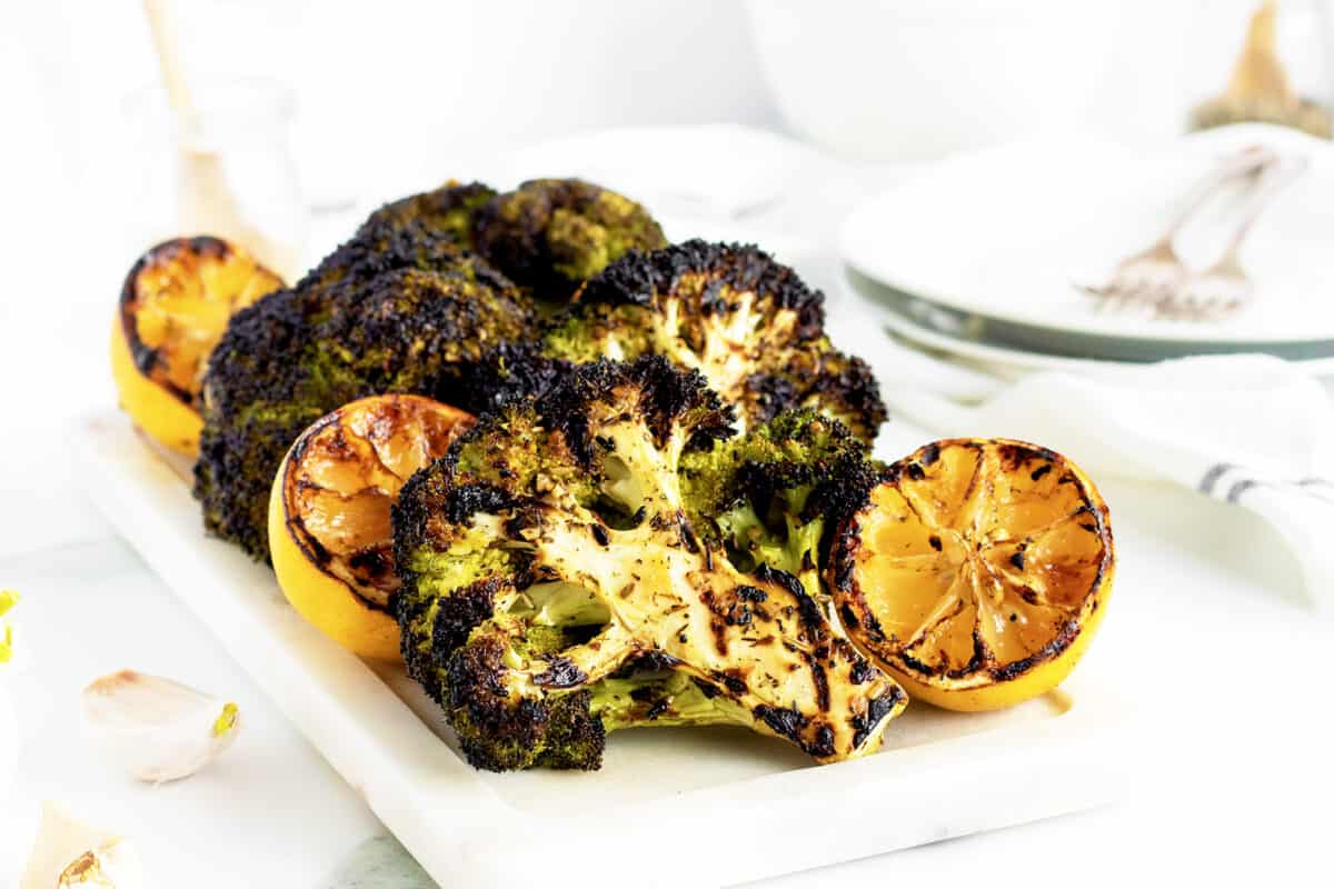 grilled broccoli on a white cutting board