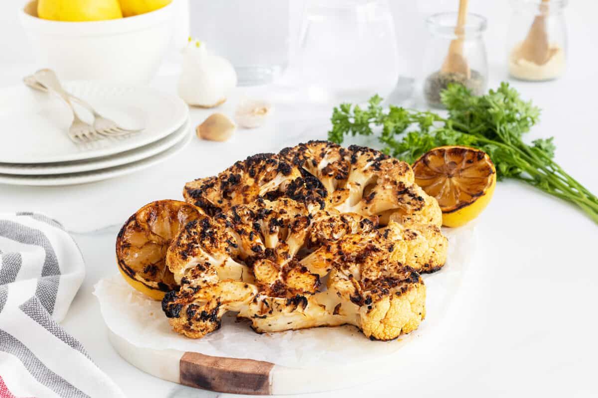 grilled cauliflower steaks on a white plate
