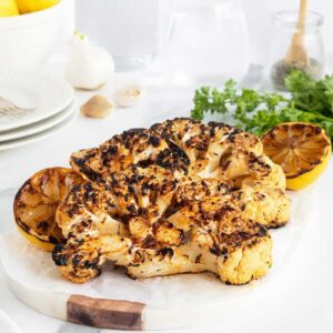 grilled cauliflower steaks on a white plate