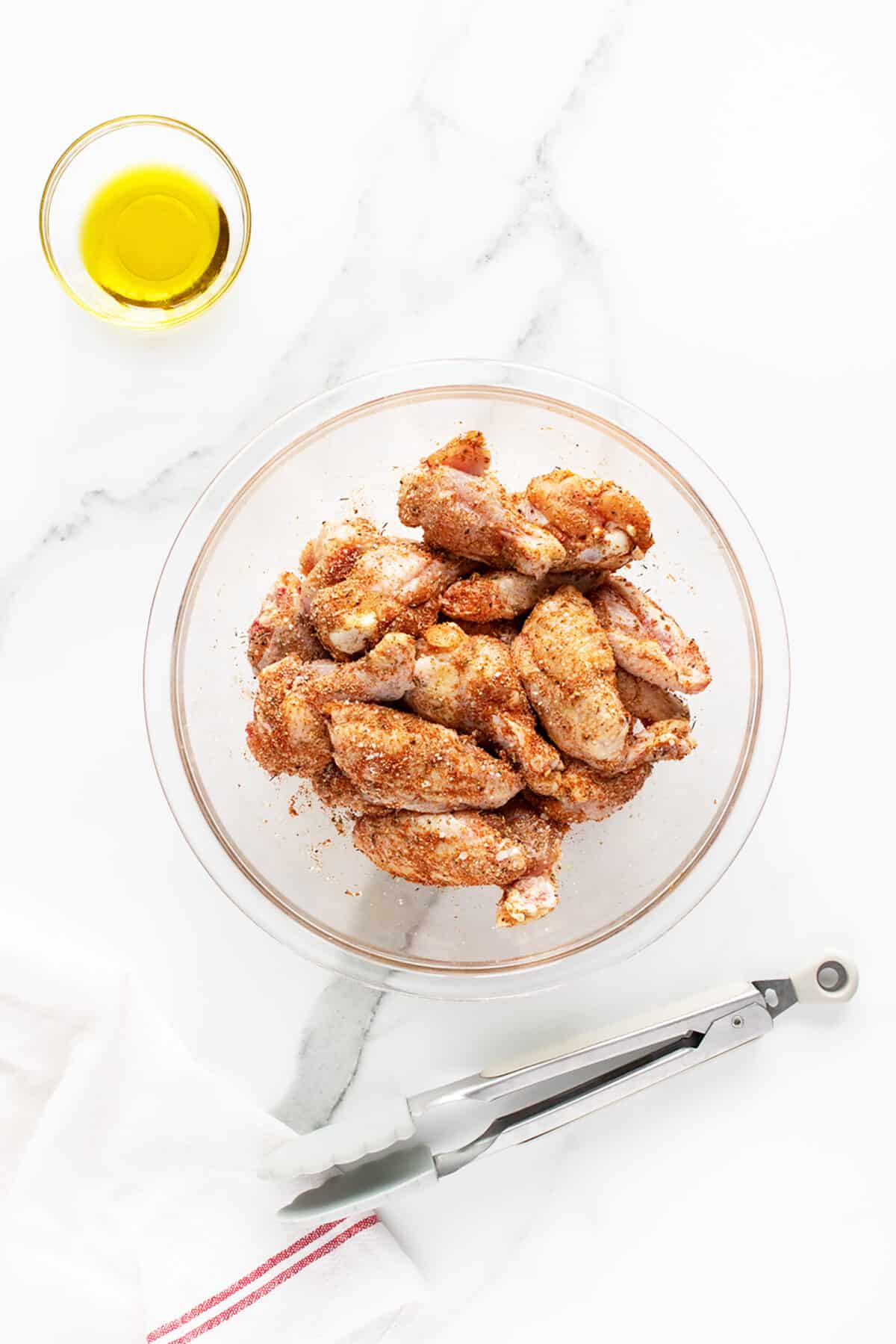 grilled chicken wings seasoned in a clear bowl