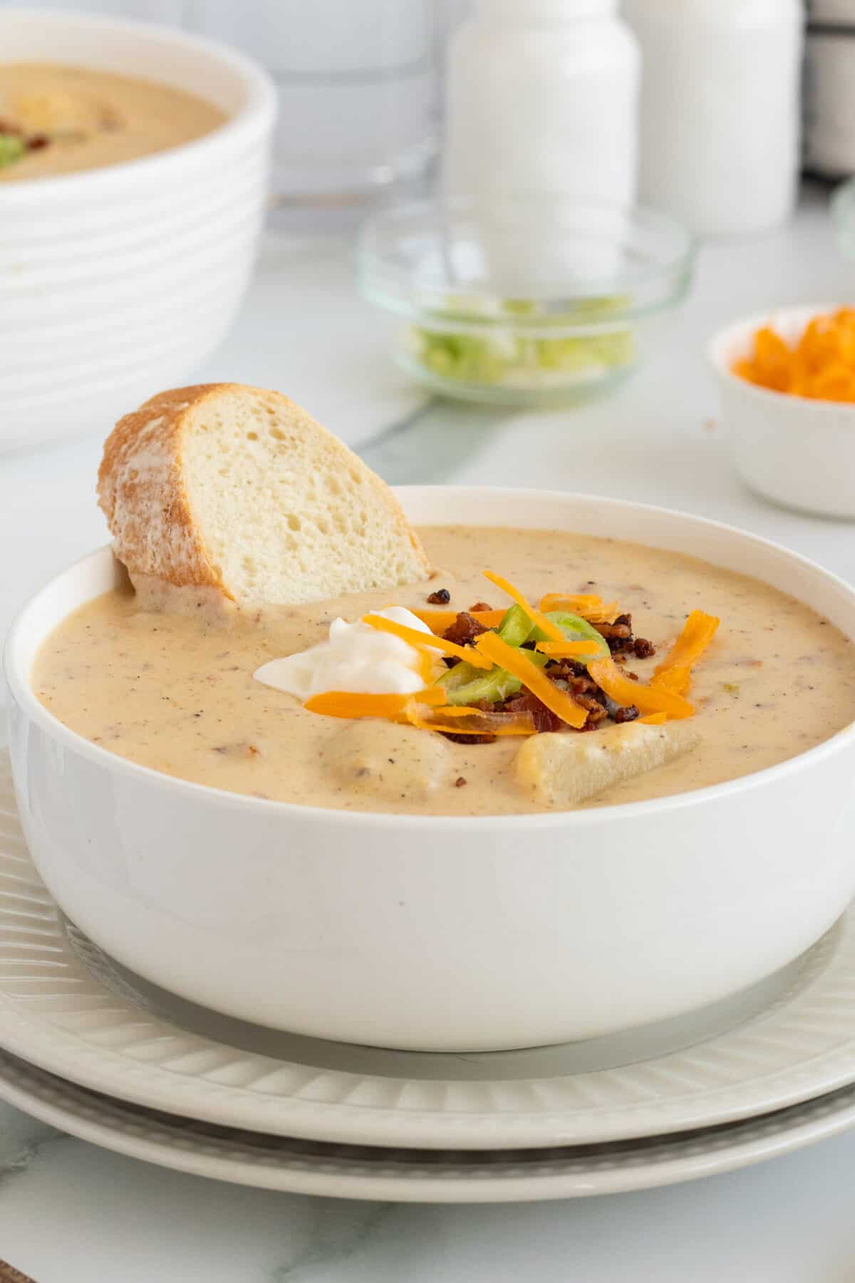 loaded baked potato soup with bread slice in the bowl