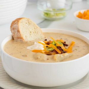loaded baked potato soup with bread slice in the bowl