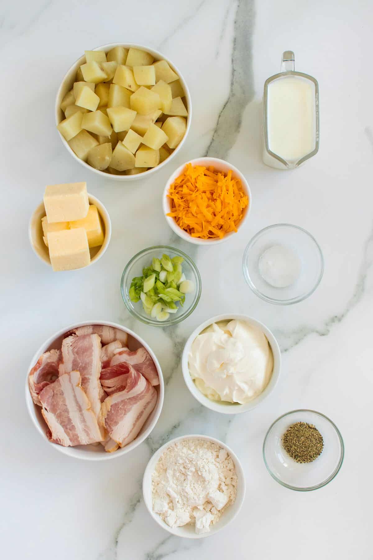 loaded baked potato soup ingredients in small bowls