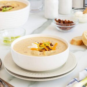 loaded baked potato soup in a bowl with toppings