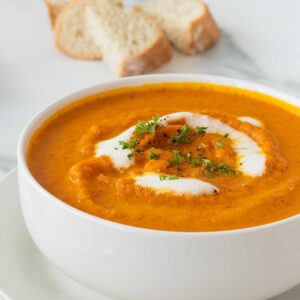 Carrot soup in a white bowl