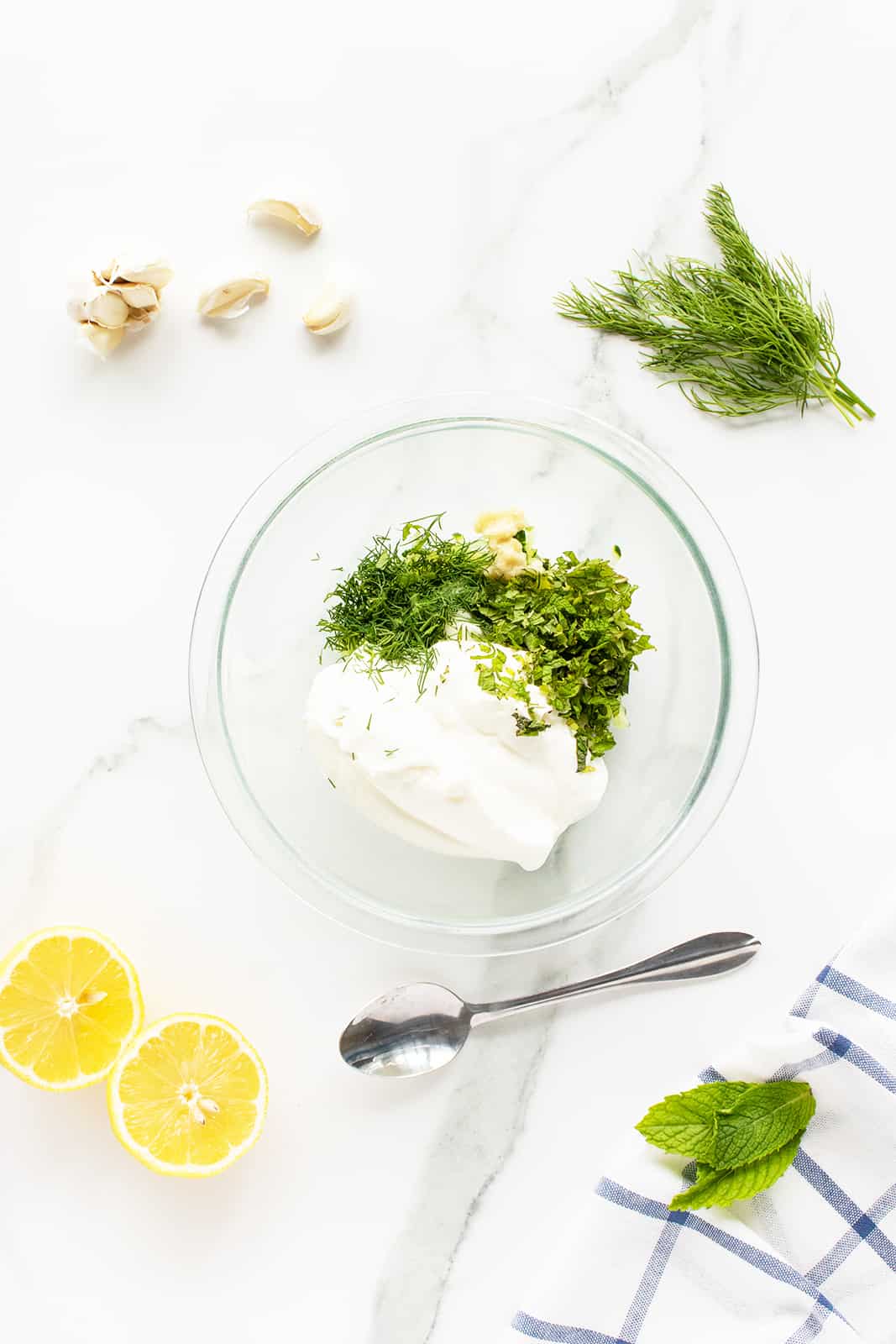 tzatziki sauce ingredients in a clear bowl