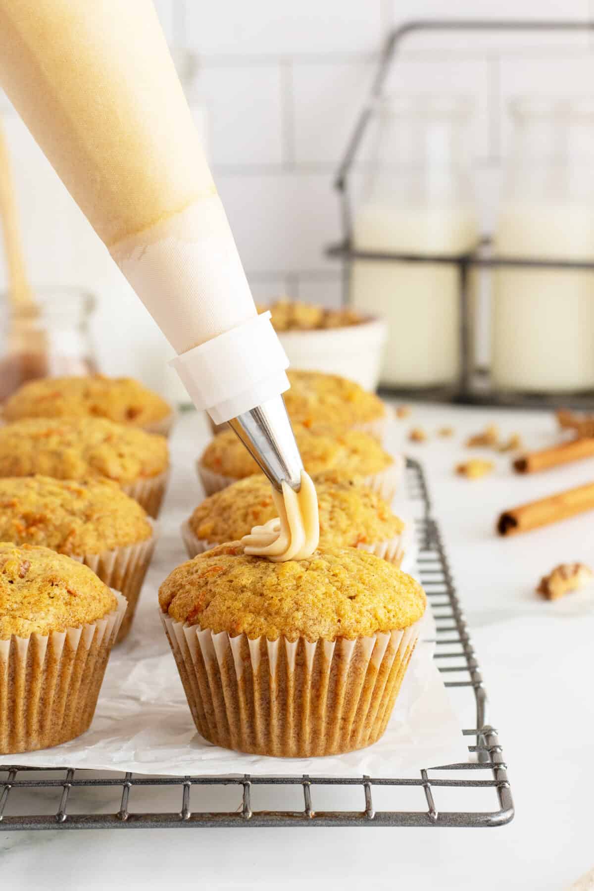 Carrot Cake Muffins being iced on a rack