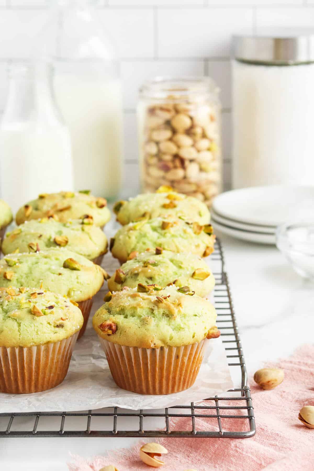 Pistachio Muffins on a cooling rack with parchment paper