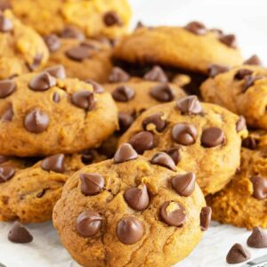 Pumpkin chocolate chip cookies on parchment paper