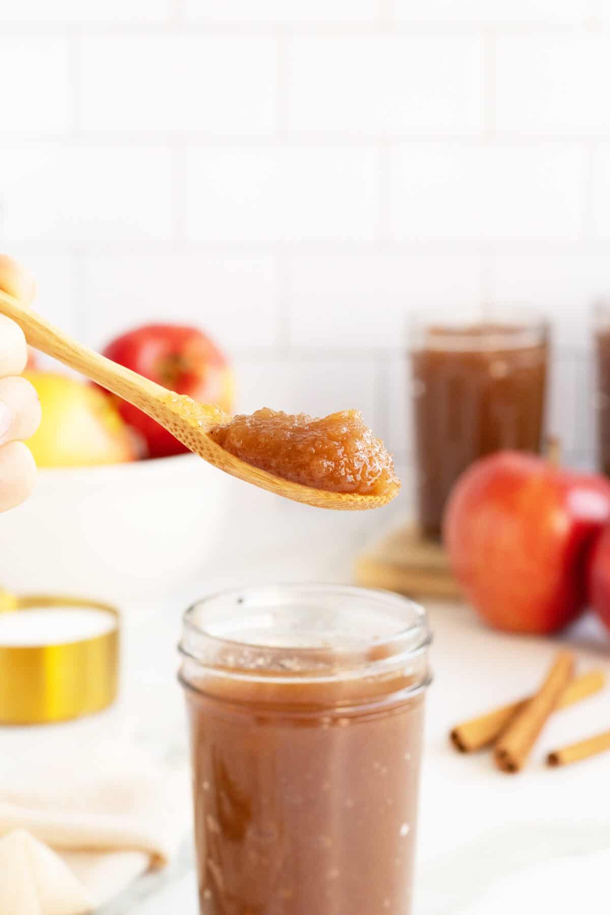 apple butter in a spoon over a jar