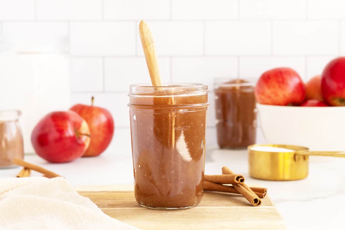 apple butter in a jar with wooden spoon