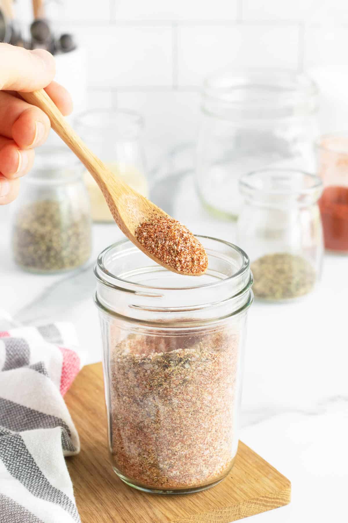 Chicken wing rub in a jar with a spoon
