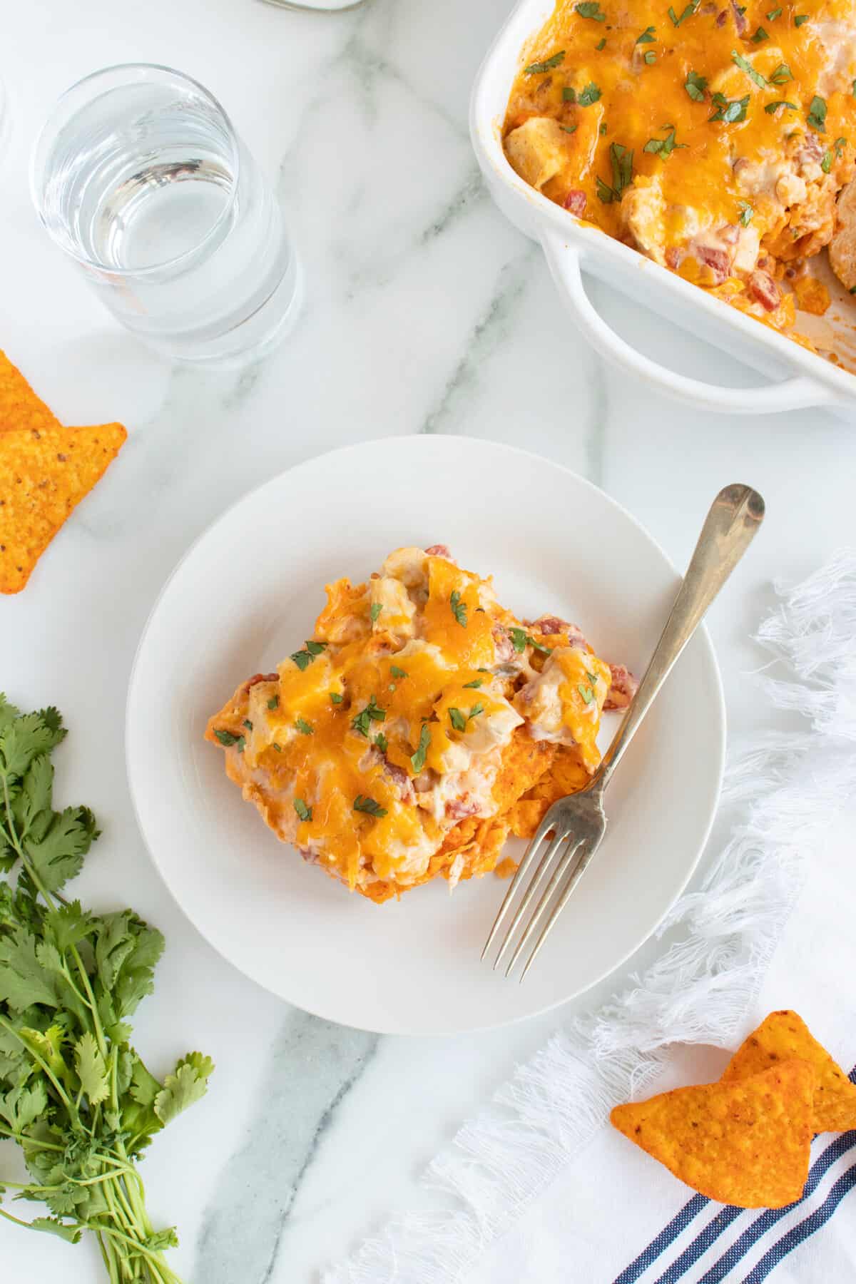Doritos Chicken Casserole on a white plate with a fork