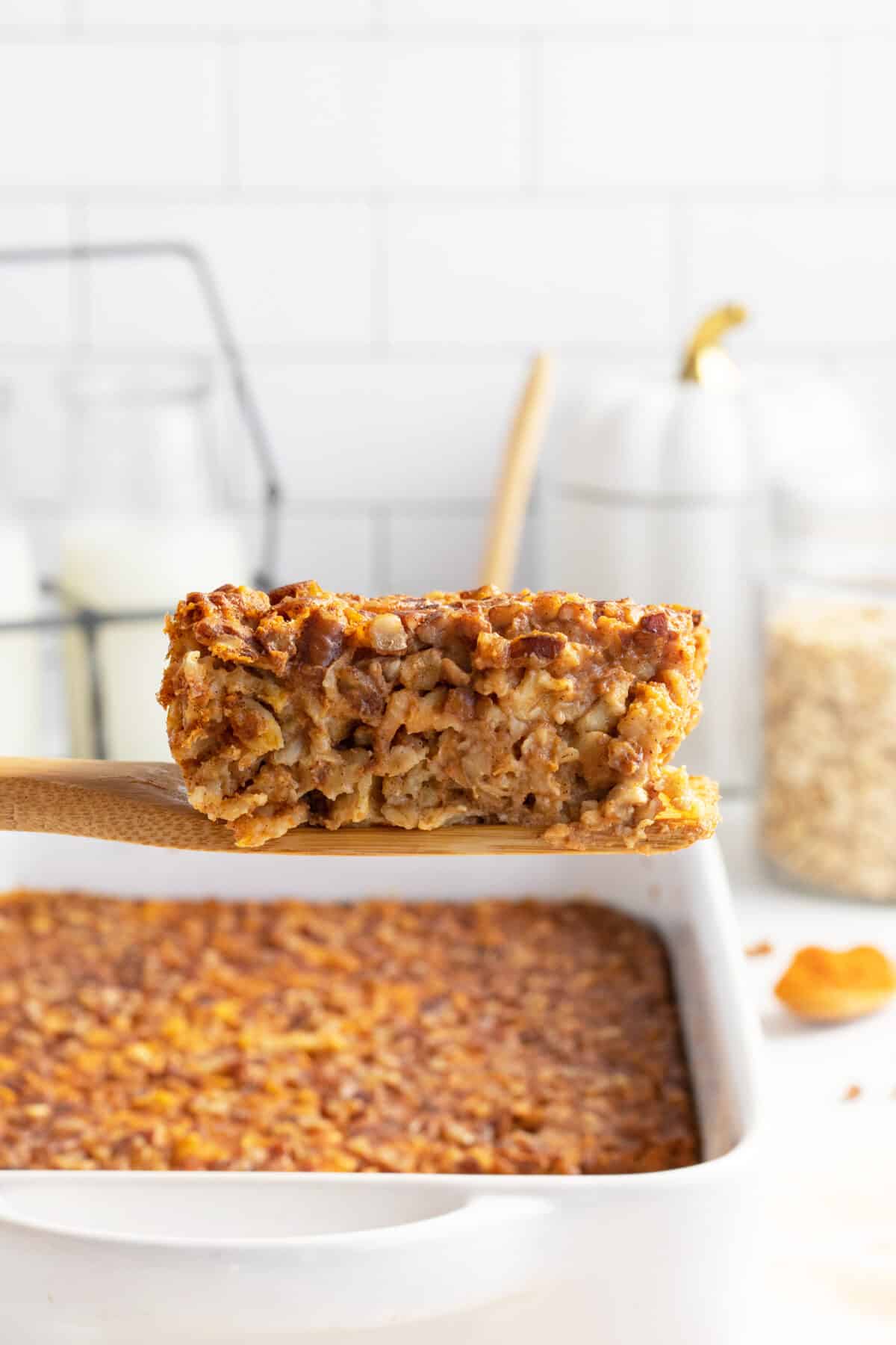pumpkin baked oatmeal slice lifted out of the pan