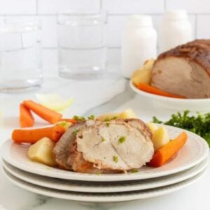 apple butter porkloin on a white plate with vegetables