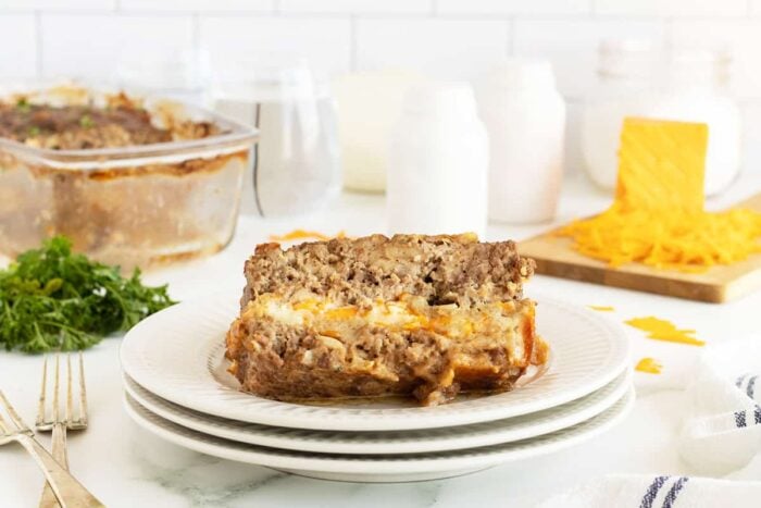 cheese stuffed meatloaf slice on a white plate